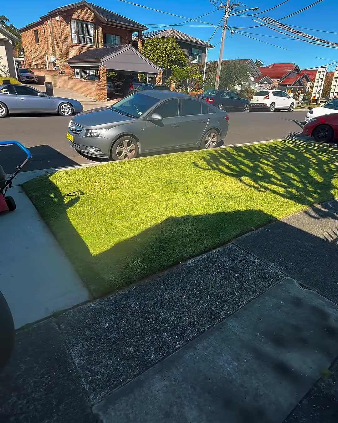 The same lawn mown with a sharp edge along the footpath